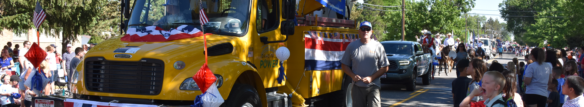 Yellow Idaho Falls Fiber truck in 4th of July parade